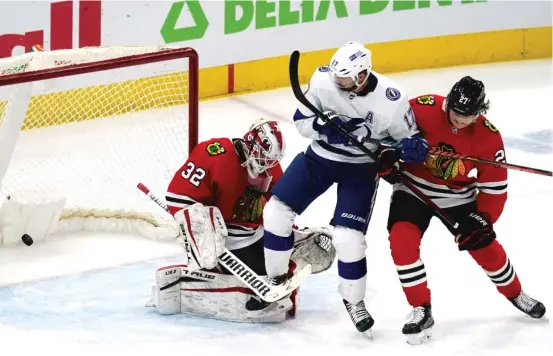  ?? NAM Y. HUH/AP ?? Blackhawks goalie Kevin Lankinen can’t make the save on the game-winning goal tipped by the Lightning’s Alex Killorn (17) as he battles Adam Boqvist.