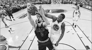  ??  ?? Cleveland Cavaliers’ Kevin Love battles for the ball with Golden State Warriors’ Draymond Green (right) during game one of the 2017 NBA Finals at Oracle Arena. — USA TODAY Sports photo