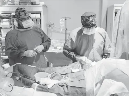  ?? NICK BRANCACCIO ?? Dr. Kushal Dighe, right, and nurse Alan Desimpel with a patient in the Cardiac Cath Lab at Windsor Regional Hospital’s Ouellette campus on Friday. “We attribute this to be a men’s disease but that’s not true,” says Dighe about women with heart disease.