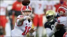  ?? BRIAN BLANCO — THE ASSOCIATED PRESS FILE ?? Clemson’s Trevor Lawrence, left, throws a pass in the ACC championsh­ip game against Notre Dame in Charlotte, N.C.