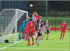  ??  ?? Dene Cassells heads over the crossbar.