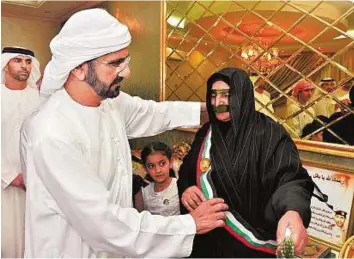  ?? WAM/Gulf News Archives ?? Martyr’s mother honoured His Highness Shaikh Mohammad Bin Rashid Al Maktoum, Vice-President and Prime Minister and Ruler of Dubai, presented the Mohammad Bin Rashid Scarf to First Lieutenant Tareq Mohammad Al Shehi’s mother when he visited her in Ras...