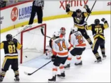  ?? GENE J. PUSKAR — THE ASSOCIATED PRESS ?? Pittsburgh Penguins captain Sidney Crosby (87) celebrates after scoring the game-winning goal in overtime past Flyers goalie Brian Elliott during a game between the teams Monday night in Pittsburgh.