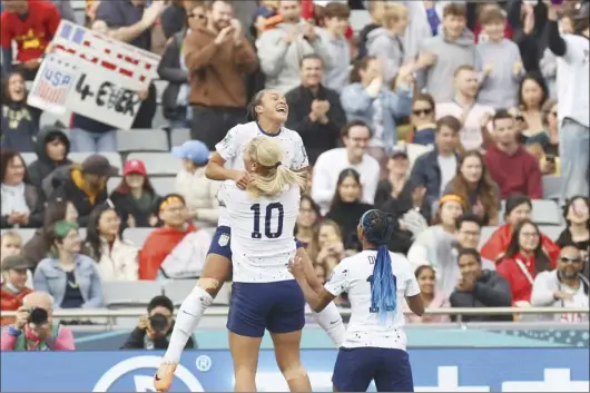  ?? AP photo ?? Sophia Smith of the United States celebrates her first goal with Lindsey Horan (10) and Crystal Dunn in the 14th minute of the Americans’ 3-0 victory over Vietnam in group play of the Women’s World Cup today in Auckland, New Zealand.