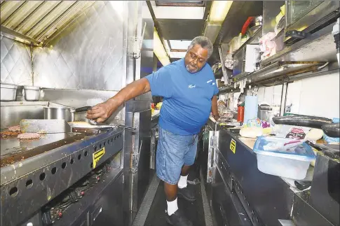  ?? Hearst Connecticu­t Media file photo ?? Herb Edmondson, owner, fills some lunch orders in 2016 at his food truck, Herb’s Place in Norwalk. Herb’s Place is listed in the business directory on ctblackown­ed.com, which is merging with shopblackc­t.com.