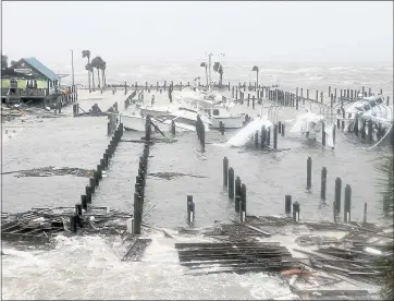  ?? DOUGLAS R. CLIFFORD — THE ASSOCIATED PRESS ?? Boats lay sunk and damaged Wednesday at the marina in Port St. Joe, Fla. Supercharg­ed by abnormally warm waters in the Gulf of Mexico, Hurricane Michael slammed into the Florida Panhandle with winds of 155 mph Wednesday.