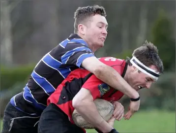  ??  ?? Shea Boggan of Wexford Wanderers tackles Bryan Harte (New Ross) in Sunday’s Division 2A derby.