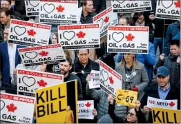  ?? CP PHOTO JEFF MCINTOSH ?? Pro-pipeline protesters gather and chant slogans outside a venue Tuesday in Calgary where Federal Finance Minister Bill Morneau was speaking.