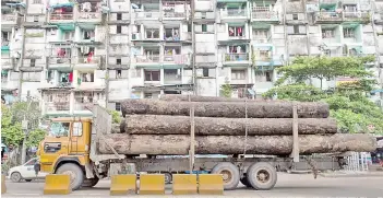  ?? — AFP file photo ?? A cargo truck transports logs in Yangon. The US Treasury placed Myanmar state-owned timber and pearl businesses on its sanctions blacklist saying they were used to generate revenue for the military regime..