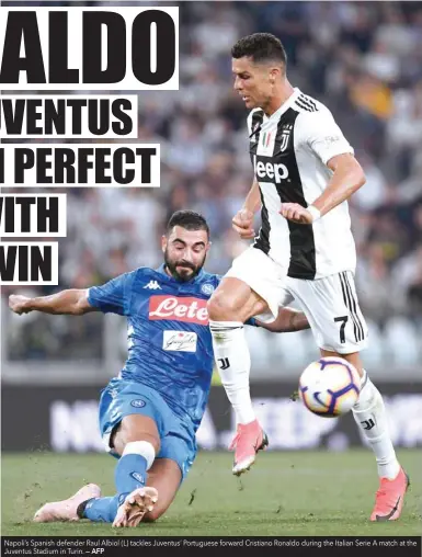  ?? — AFP ?? Napoli’s Spanish defender Raul Albiol (L) tackles Juventus’ Portuguese forward Cristiano Ronaldo during the Italian Serie A match at the Juventus Stadium in Turin.