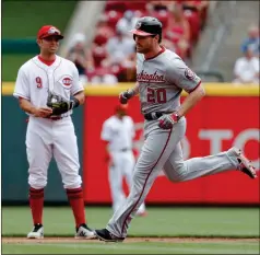  ?? John Minchillo / The Associated Press ?? Washington’s Daniel Murphy (20) runs the bases after hitting a two-run home run off Cincinnati starting pitcher Homer Bailey on Sunday in Cincinnati.