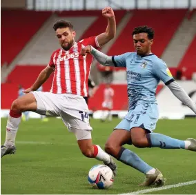  ??  ?? Coventry City’s Sam Mccallum takes on Stoke’s Tommy Smith