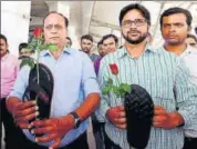  ?? PTI FILE ?? Aam Aadmi Sena activists hold roses and slippers as they protest against Shiv Sena MP Ravindra Gaikwad over his misbehavio­ur with an Air India staffer, at IGI Airport in New Delhi.
