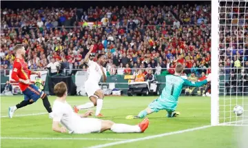  ??  ?? Raheem Sterling (centre) scores their third goal past Spain’s David De Gea during the UEFA Nations League match at the Benito Villamarin stadium in Sevilla. — Reuters photo