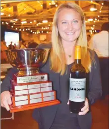  ?? STEVE MacNAULL/The Okanagan Weekend ?? Sandhill Wines territory manager Melody Schneider poses with the trophy and Premier’s Award wine of the year, Sandhill Terroir Driven 2015 Syrah ($22), at Thursday night’s British Columbia Wine Awards at the Laurel Packinghou­se in Kelowna.