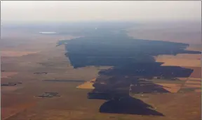  ?? SUBMITTED PHOTOS BOB OLSON ?? Top: A grassfire that burned through the night Monday and well into Tuesday south of Bindloss near the northern edge of Cypress County made its way into ranch land, destroying this residence and farm. Above: Aerial photos show the vast area of land...