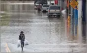  ?? SHMUEL THALER — SANTA CRUZ SENTINEL FILE ?? A Pajaro resident salvages belongings from his flooded home on March 11.