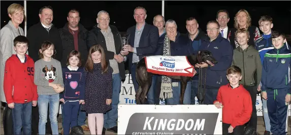 ??  ?? Winning owner Alan Williams, fourth from left, accepts the winner’s trophy from sponsor Tom Nolan after Hoycross Lad won the T. Nolan CVRT Test Centre Kingdom Derby Final at the Kingdom Stadium. Included, from left, Mary O’Kelly, Kieran Casey (KGS...