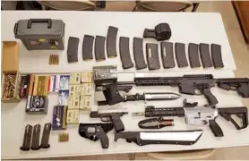  ?? WASHINGTON COUNTY SHERIFF VIA AP ?? A cache of weapons is displayed in Johnson City, Tenn. Federal agents are trying to determine why Scott Edmisten, a man pulled over for speeding, was carrying a cache of weapons including two submachine guns and hundreds of rounds of ammunition.