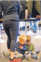  ?? ADOLPHE PIERRE-LOUIS/JOURNAL ?? Brothers Barrett, 20 months, left, and Taetum, 3, play while parents Connie and Braysen Deering attend to the serious business of voting at the Petroglyph Plaza voting site on Albuquerqu­e’s West Side.