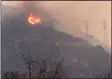  ?? MIKE ELIASON — SANTA BARBARA COUNTY FIRE DEPARTMENT ?? Spot fires burn near power lines as heavy smoke fills the air from a wildfire in Santa Barbara.