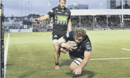  ??  ?? Callum Gibbins dives over in the corner, completing a wonderful move for Glasgow’s opening try at Scotstoun.