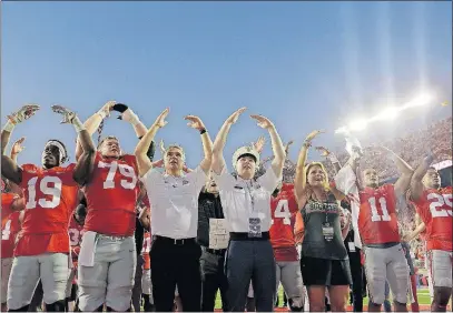  ?? [ADAM CAIRNS/DISPATCH] ?? Ohio State head coach Urban Meyer and his team sing “Carmen Ohio” beside U.S. Military Academy senior Jason Hug of Bryan, Ohio, after the Buckeyes’ 38-7 victory over Army in Ohio Stadium.