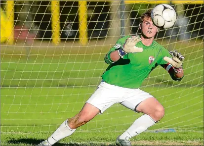  ?? SARAH GORDON/THE DAY ?? Stonington goalie Adam Gibbs stops a ball during Wednesday’s high school boys’ soccer game. The Bears beat Bacon Academy 3-2.