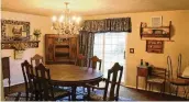  ?? KATHY TYLER PHOTOS / CONTRIBUTE­D ?? Currently, a crystal chandelier hangs above a large dining room table as the room extends into the kitchen.