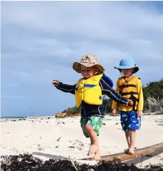  ??  ?? Two boys create their own obstacle course on the beach at Salt Island. When sailing with children, it’s helpful to spend some time ashore each day to let them run and play.