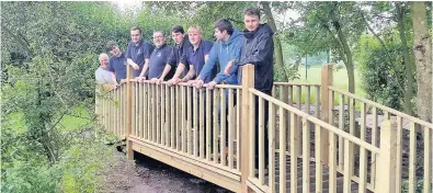  ??  ?? Joinery staff and students at Riverside College have been helping the community by designing and building an outdoor activity area at St Michael’s Catholic Primary School in Widnes