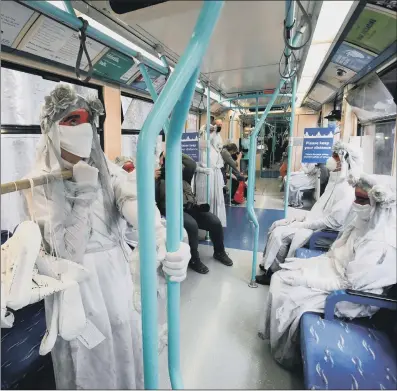  ?? PICTURES: GETTY IMAGES ?? SHOE PROTEST: Above, activists from Extinction Rebellion take 26 shoes, representi­ng the people who die from air pollution in London each day, on a DLR train to the Transport For London offices in Stratford; inset, the ‘ banshees’ perform in General Gordon Place, Woolwich.