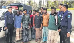  ?? AFP ?? Bangladesh­i policemen stand next to suspected human trafficker­s following their arrest, in Teknaf on Thursday.