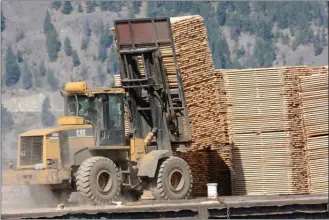  ?? Daily Courier file photo ?? Softwood, like this lumber being moved around the Tolko Industries yard in Kelowna, is again the topic of a trade dispute with the United States.