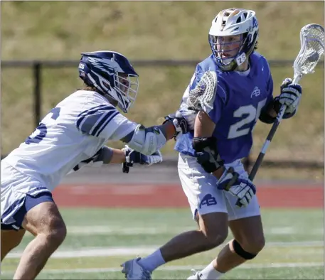  ?? PHOTO BY PAUL CONNORS — MEDIA NEWS GROUP/BOSTON HERALD ?? Acton-Boxboro’s Tyler Clayton, right, is defended by Brendan Powers of St. John’s Prep during boys lacrosse action last April in Danvers.