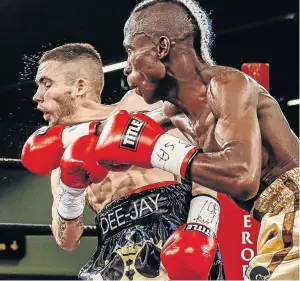  ?? / NICK LOURENS ?? Dee-Jay Kriel takes a hard right from Nyelisani Thagambega who will make his profession­al debut in Venda.