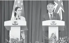  ?? — AFP photo ?? Ardern (left) and Lee attend a joint press conference at the Istana Presidenti­al palace in Singapore.