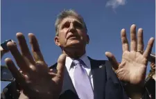  ?? AP file ?? HOLD YOUR HORSES: Sen. Joe Manchin, D-W.Va. updates reporters about his position on President Biden’s $3.5T government overhaul at the Capitol in Washington, D.C., on Thursday.
