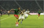  ?? AP ?? Cameroon's Eric Maxim Choupo-moting, left, dribbles during the African Cup of Nations 2022 round of 16 soccer match between Cameroon and Comoros at the Olembe stadium in Yaounde, Cameroon, Monday. At least people died in a crush of people trying to get in to see a game.