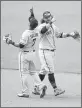  ?? DENIS POROY — GETTY IMAGES ?? The Giants’ Donovan Solano, left, and Brandon Crawford celebrate after the Giants beat the Padres 3-2 on Wednesday in San Diego.