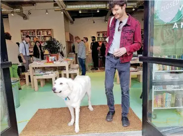  ?? [PHOTO BY STEVE LACKMEYER, THE OKLAHOMAN] ?? Boz, the shop dog at Commonplac­e Books, welcomes visitors and will sometimes cozy up with book lovers who choose to stay and linger.