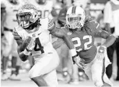  ?? WILFREDO LEE/ASSOCIATED PRESS ?? Sheldrick Redwine (22) made the switch from cornerback to safety for the Hurricanes during the spring.