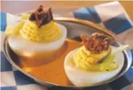  ??  ?? Deviled eggs with crispy pork cheek.