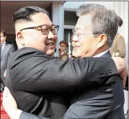  ?? AP ?? North Korean leader Kim Jong Un (left) and South Korean President Moon Jae-in embrace Saturday after two hours of talks on the north side of Panmunjom in the demilitari­zed zone between their countries.
