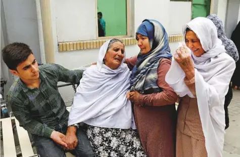  ?? Reuters ?? Relatives of the victims mourn at a hospital after a suicide attack in Kabul, Afghanista­n, yesterday.