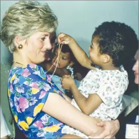  ?? Associated Press file photos ?? LEFT: Britain’s Princess Diana hugs and plays with an HIV positive baby in Faban Hostel, San Paulo, on the second day of her visit to Brazil on April 24, 1991. RIGHT: Diana, the Princess of Wales, is pictured during an evening reception given by the...