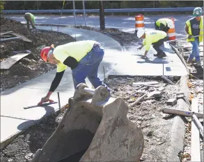  ?? Brian A. Pounds / Hearst Connecticu­t Media ?? With fewer workplace injuries in Connecticu­t and lower claims payouts, workers compensati­on insurance rates will drop a sixth straight year in 2020. Workers from Grasso Companies of Norwalk build a sidewalk in Ansonia on Oct. 21.