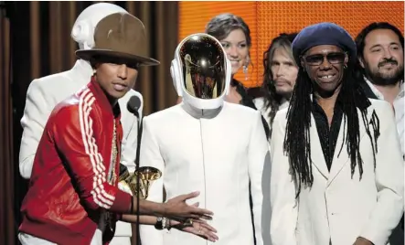  ?? Kevork Djansezian/AFP/Getty Images ?? Pharrell Williams, left, Thomas Bangalter and Guy-Manuel De Homem-Christo of Daft Punk, and Nile Rodgers accept the record of the year award for Get Lucky at the 56th Grammy Awards Sunday night in Los Angeles.