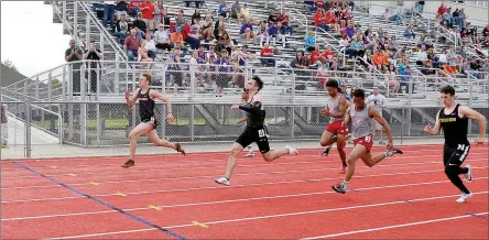  ?? TIMES photograph by Annette Beard ?? Blackhawk freshman Patrick Elliott (far left) pulled the upset in the 100-meter, racing out to a gold medal in 11:20, just ahead of brother senior Cooper Elliott (second from left) who was second in 11.34 Tuesday, April 23, in the 4A-1 District meet in Blackhawk Stadium.