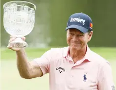  ??  ?? Tom Watson celebrates with the trophy after winning the Par 3 Contest prior to the start of the 2018 Masters Tournament at Augusta National Golf Club in Augusta, Georgia. — AFP photo
